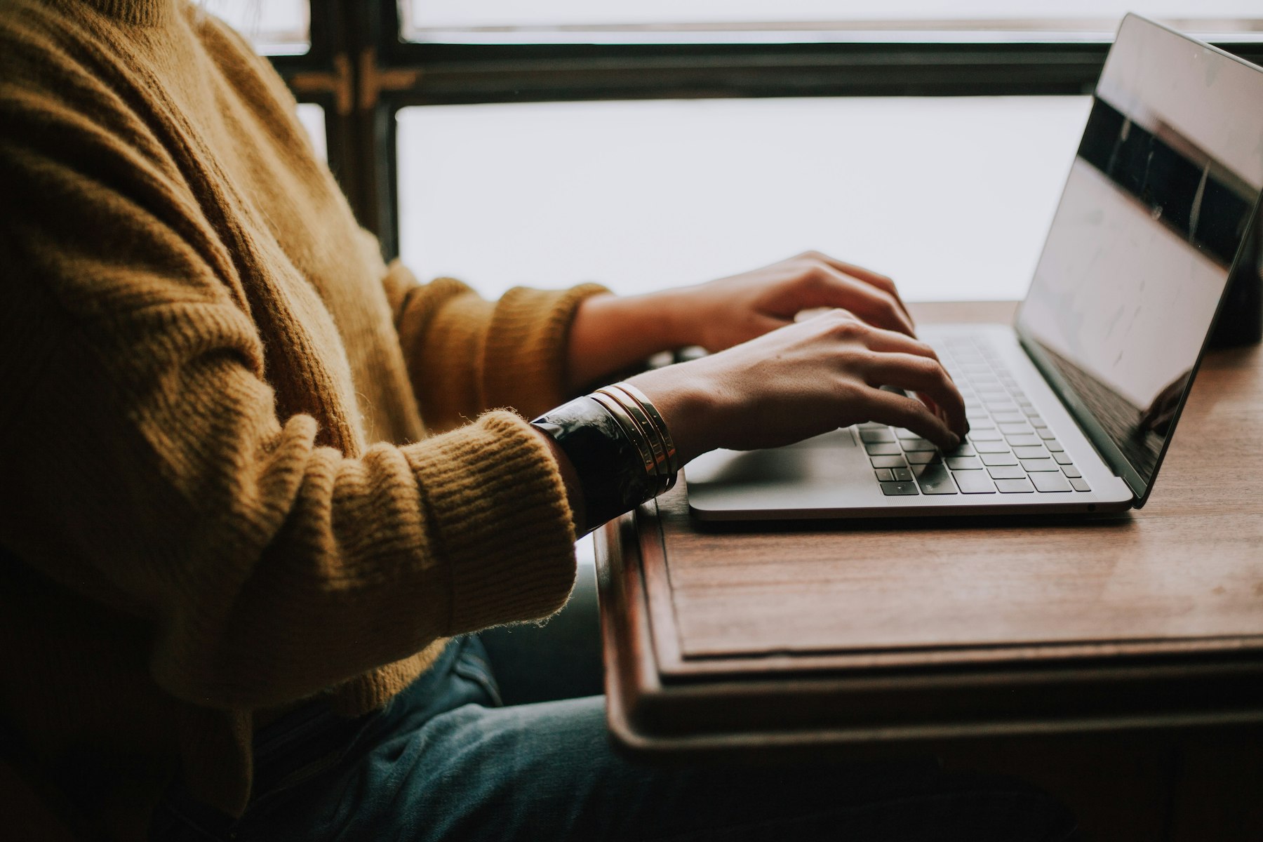 A person working on a laptop in a cafe